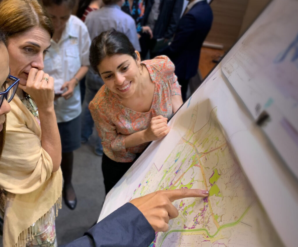 Women examining a map during a workshop in Panama City, showcasing JBA’s expertise in training and capacity building to strengthen climate and disaster resilience | JBA Global Resilience.