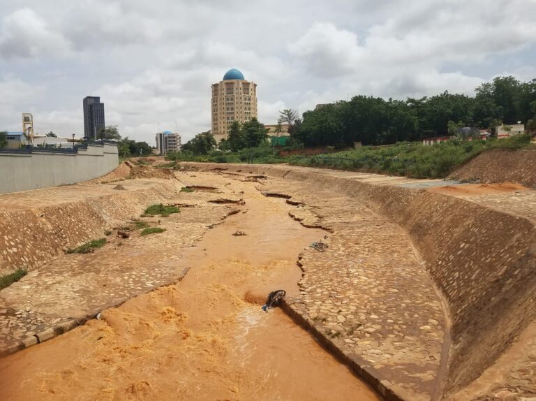 Arid riverbed through urban area.