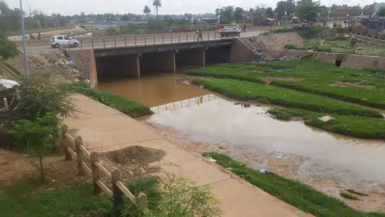 River flowing under a concrete bridge.