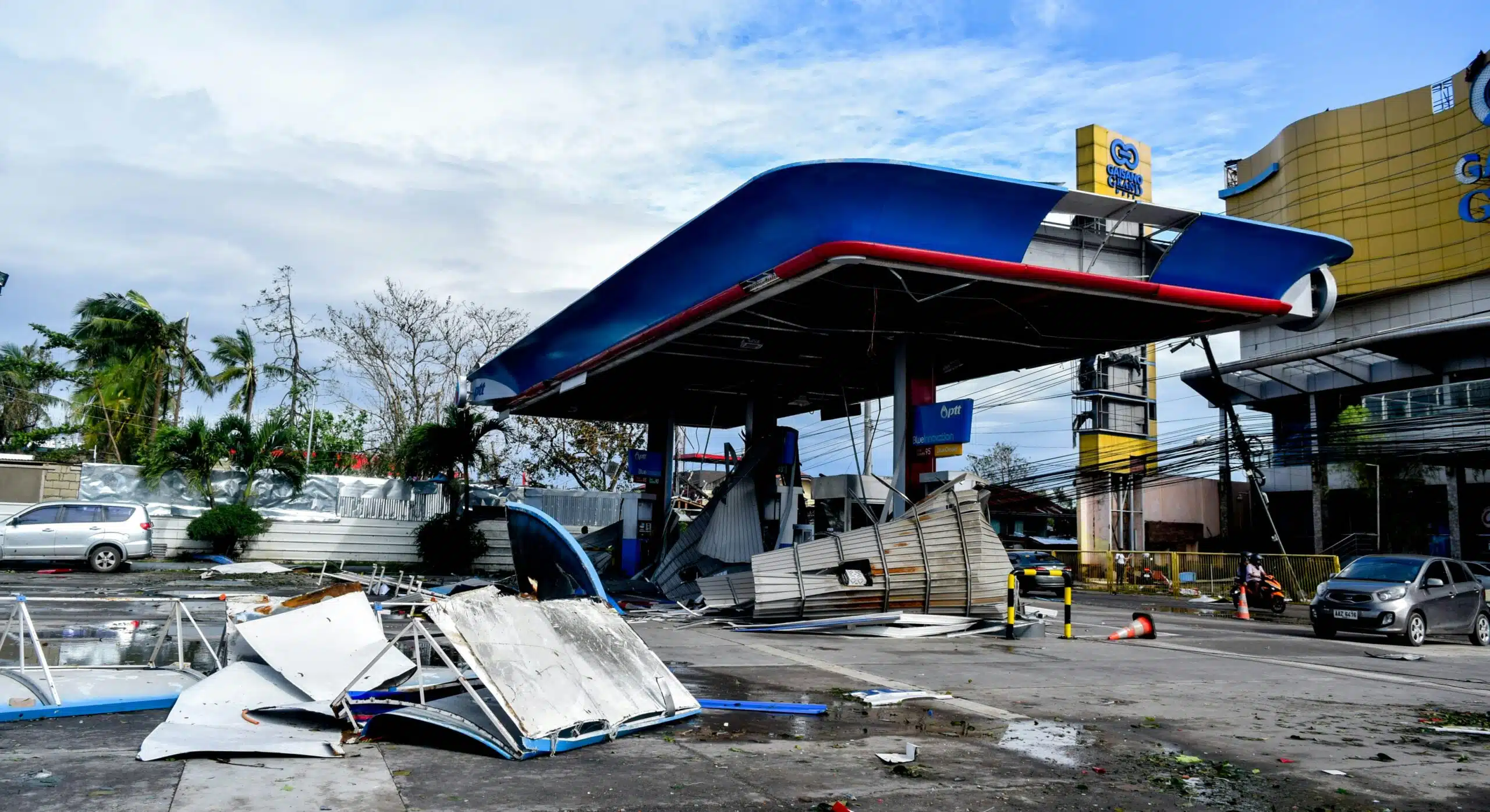 A damaged fuel station and scattered debris following Super Typhoon Odette in Lapu-Lap City, Cebu, Philippines. Showing severe wind and flood impacts on urban infrastructure.