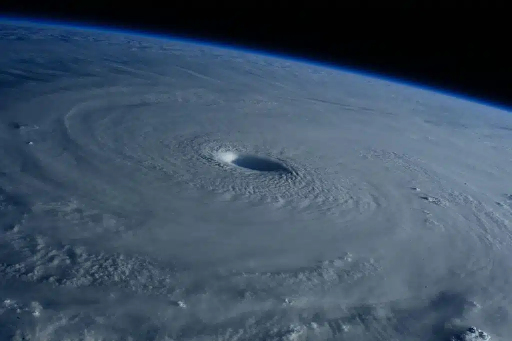 Satellite image showing a powerful tropical cyclone over the ocean, with a clearly defined eye and spiral cloud bands approaching land.