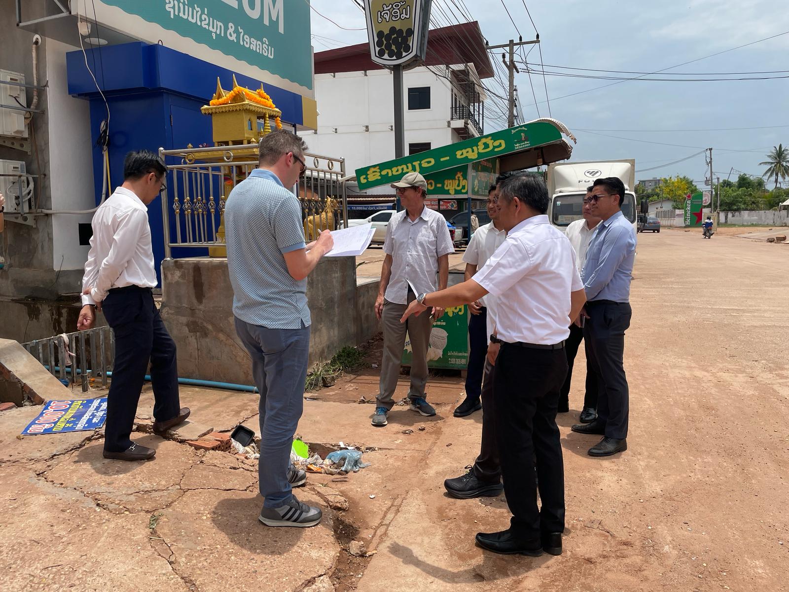 Project team reviewing site conditions and plans during an on‑site field discussion in an urban area.