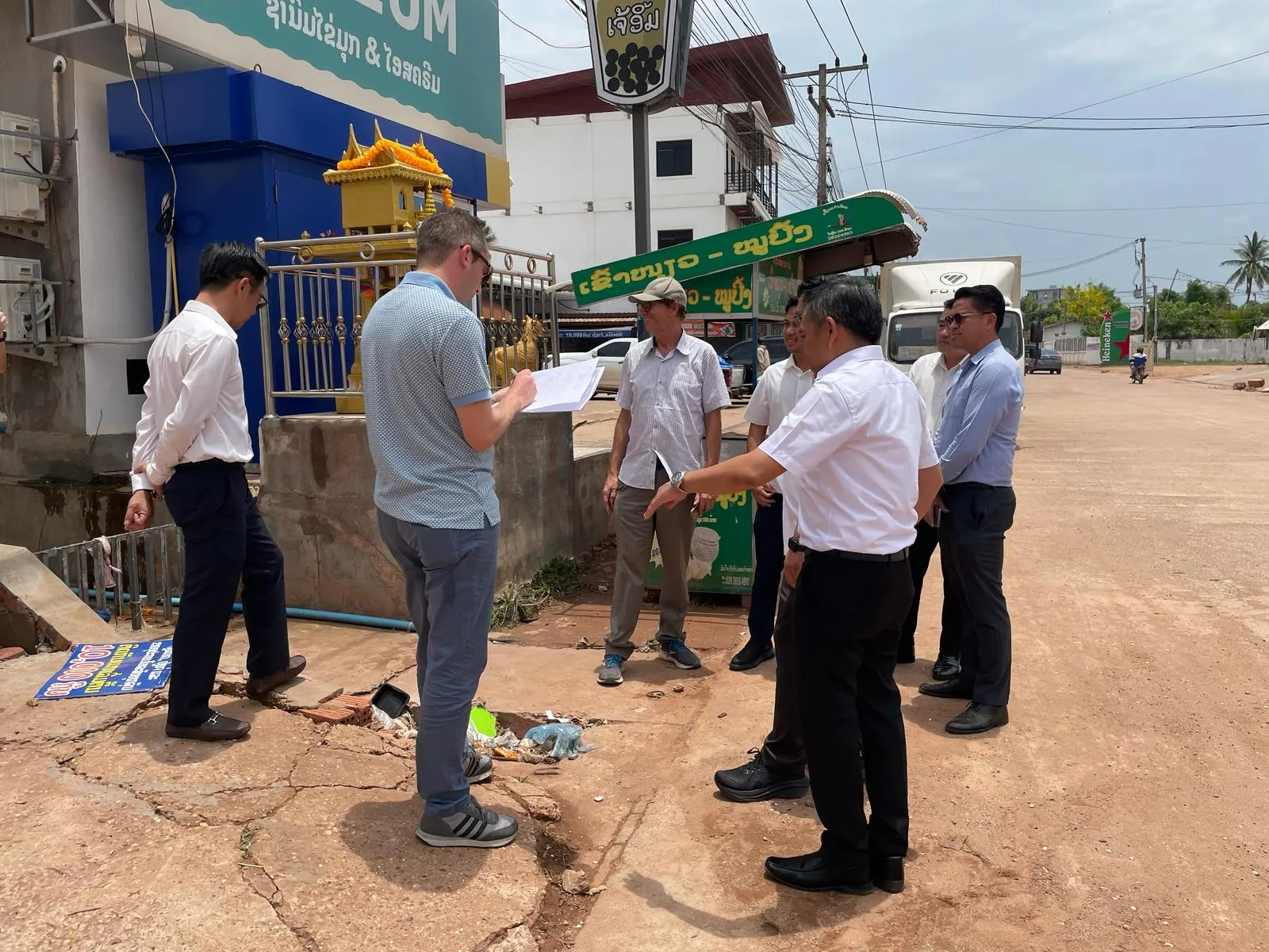 Project team reviewing site conditions and plans during an on‑site field discussion in an urban area.