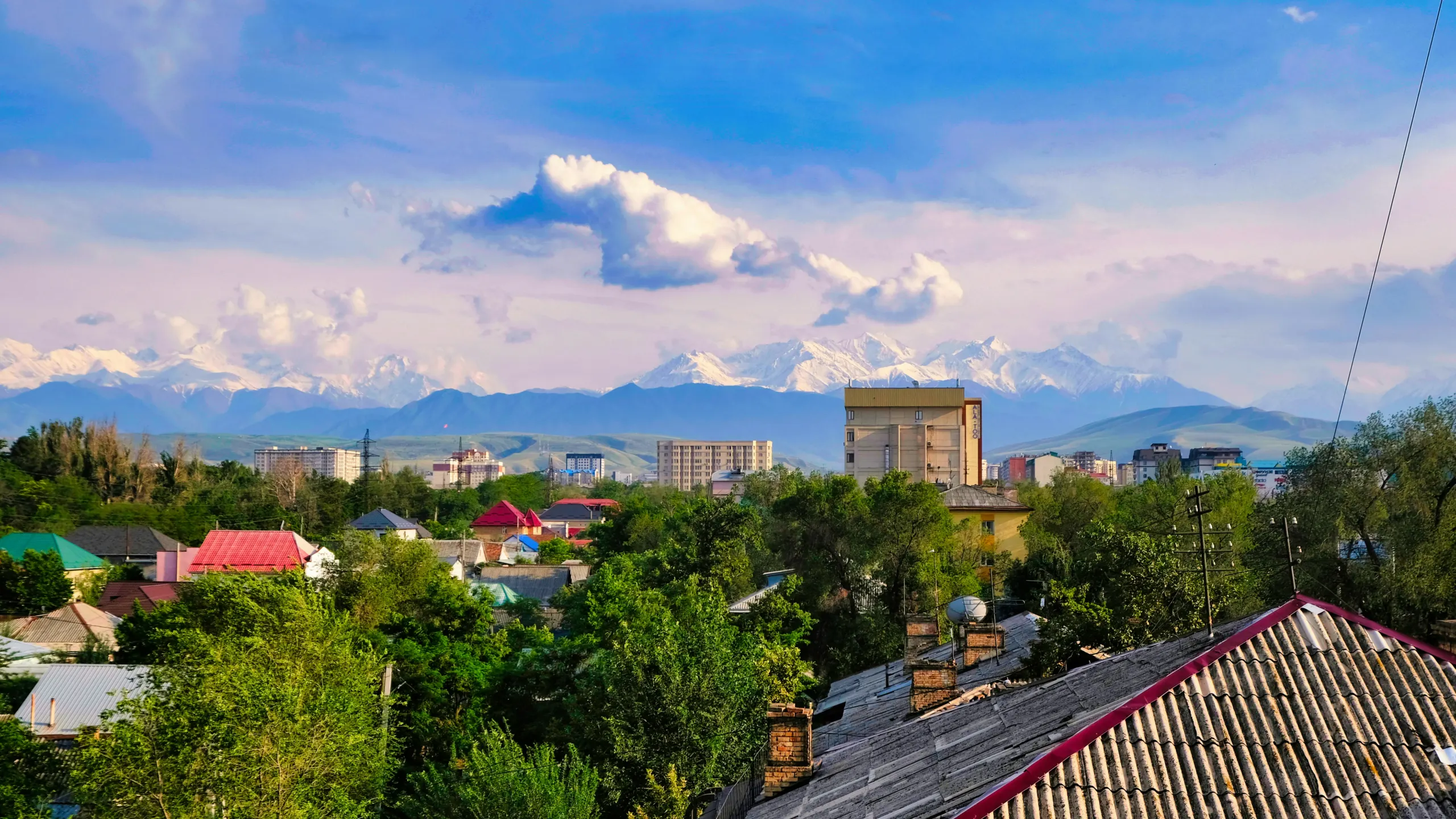 Urban landscape with snow topped mountains in the background, Kyrgyz Republic